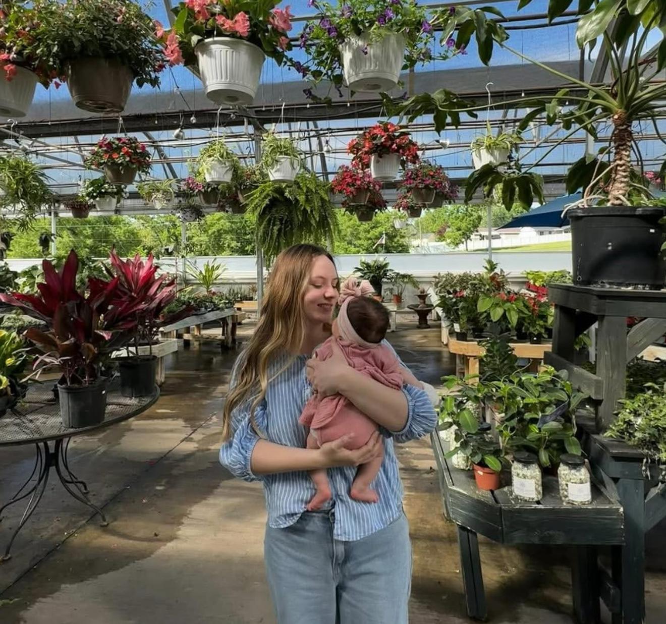 Ashley, founder of Nomadz Gear, holding her baby daughter
